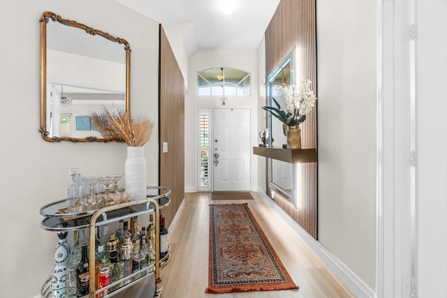 interior space with light wood-type flooring and lofted ceiling