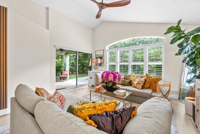 living room with light hardwood / wood-style floors, ceiling fan, and lofted ceiling