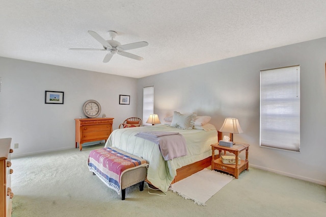 carpeted bedroom featuring a textured ceiling and ceiling fan