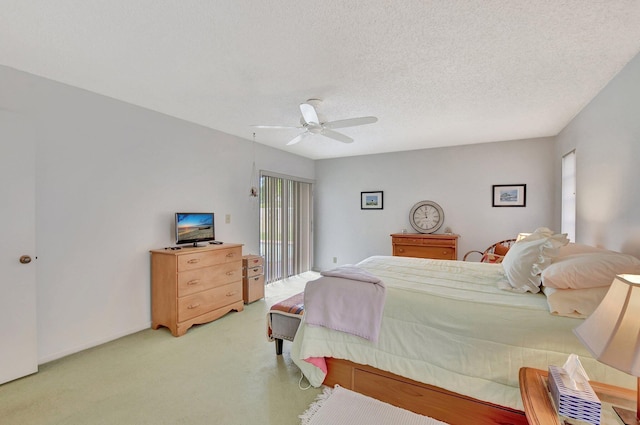 bedroom with multiple windows, a textured ceiling, and ceiling fan