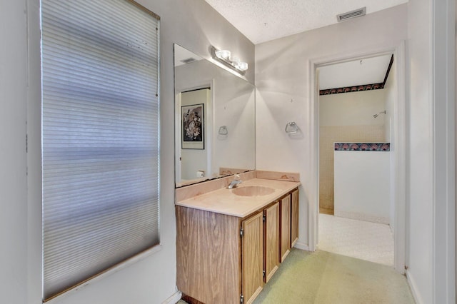 bathroom with vanity and a textured ceiling