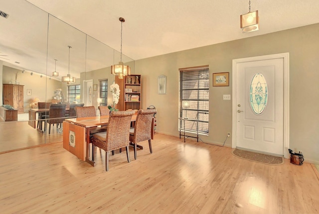 dining space with a healthy amount of sunlight and light hardwood / wood-style floors