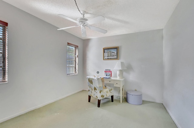 office area with light carpet, a textured ceiling, and ceiling fan