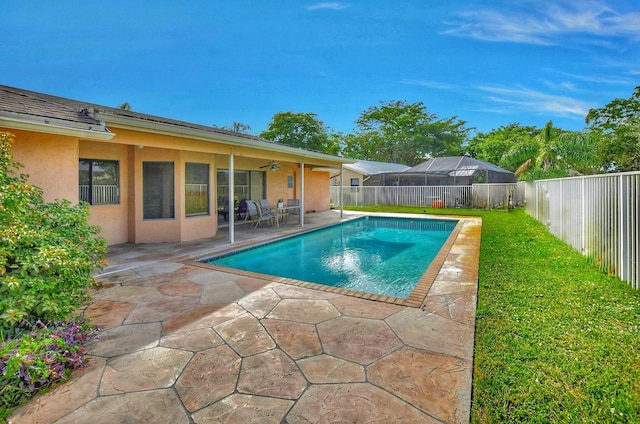 view of pool featuring a lawn, ceiling fan, and a patio area