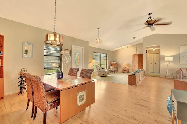 dining room with ceiling fan, light hardwood / wood-style floors, and lofted ceiling