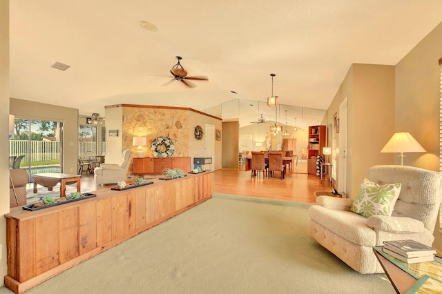 living room with light colored carpet, vaulted ceiling, and ceiling fan