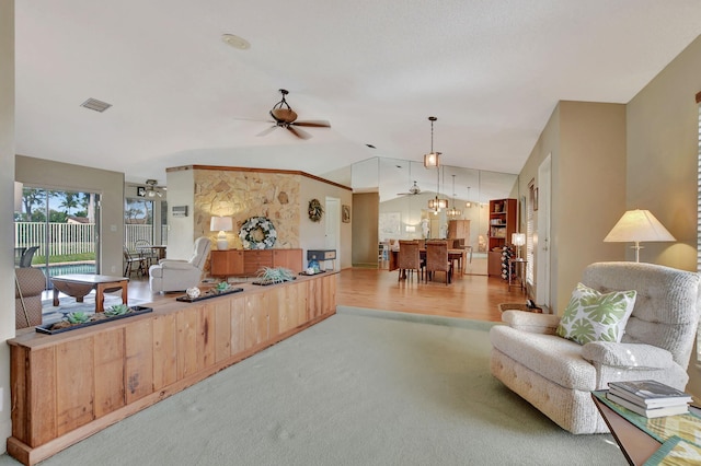 carpeted living room featuring lofted ceiling and ceiling fan