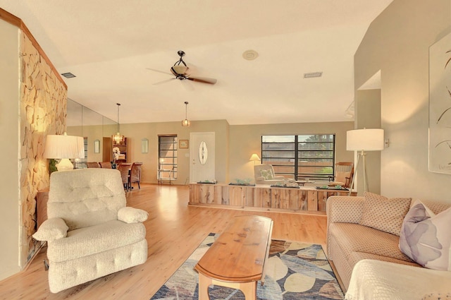 living room with ceiling fan, light hardwood / wood-style flooring, and lofted ceiling