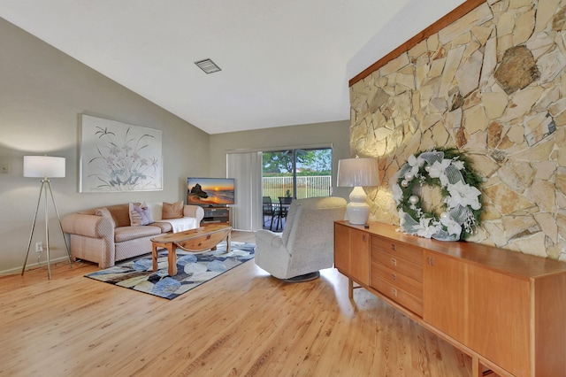 living room with lofted ceiling and light wood-type flooring