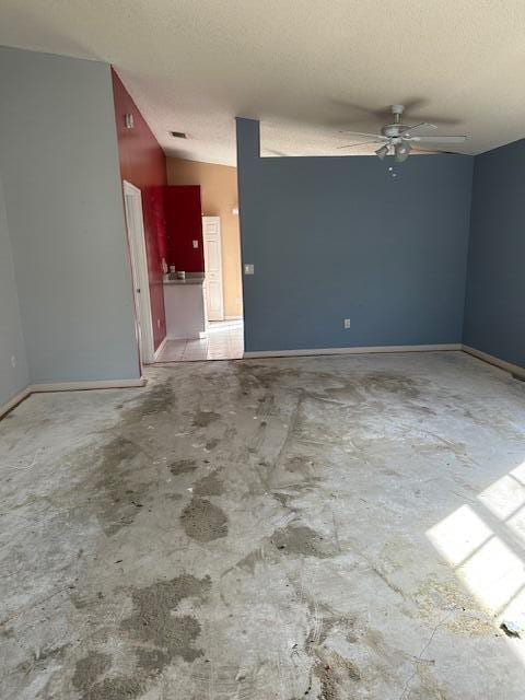 empty room featuring ceiling fan and a textured ceiling