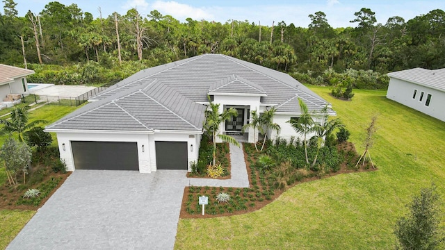 view of front facade featuring a front lawn and a garage