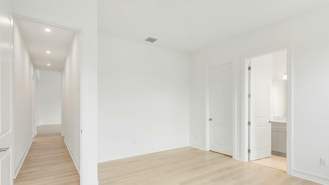 hallway with light hardwood / wood-style floors