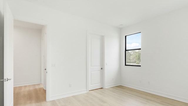 spare room with light hardwood / wood-style flooring