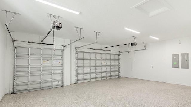 garage with electric panel and a garage door opener