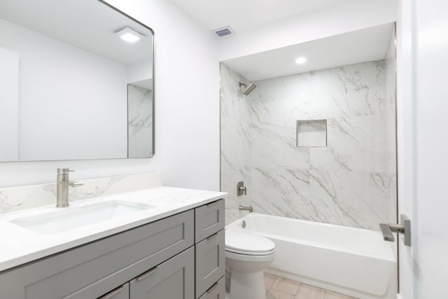 full bathroom with toilet, vanity, and tiled shower / bath