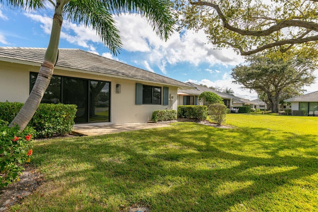 back of property featuring a lawn