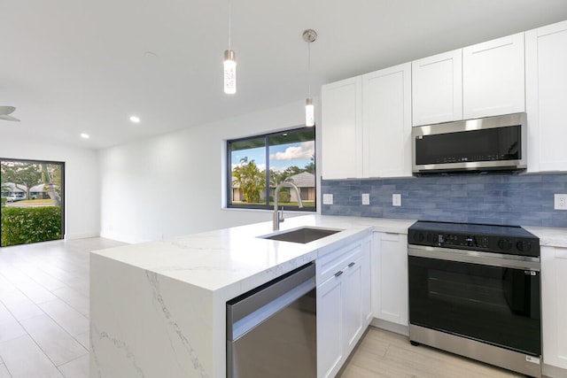 kitchen with white cabinets, a healthy amount of sunlight, sink, and appliances with stainless steel finishes