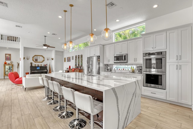 kitchen featuring visible vents, appliances with stainless steel finishes, and light wood-type flooring