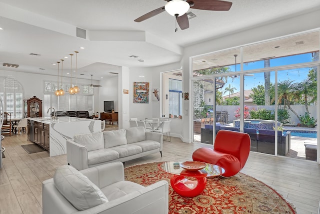 living area featuring light wood-style flooring, recessed lighting, visible vents, and ceiling fan