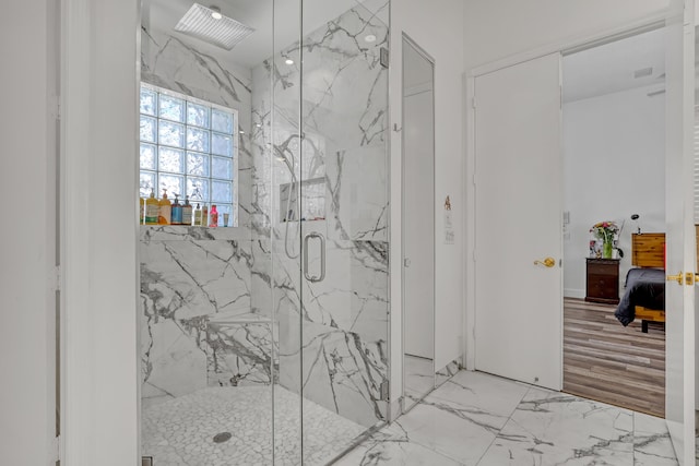 bathroom featuring marble finish floor, a marble finish shower, and connected bathroom