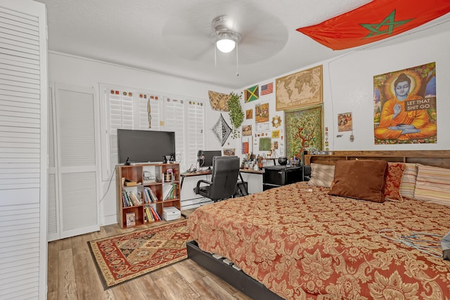 bedroom featuring wood finished floors and a textured ceiling