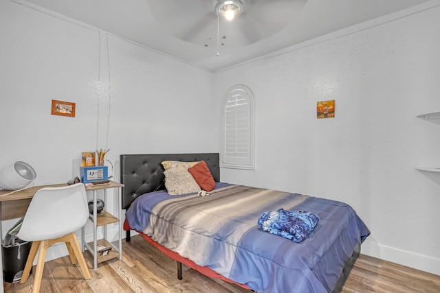 bedroom with wood finished floors, baseboards, and ceiling fan