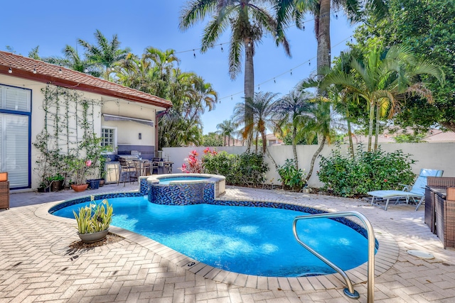 view of pool with a patio, a fenced backyard, and a pool with connected hot tub