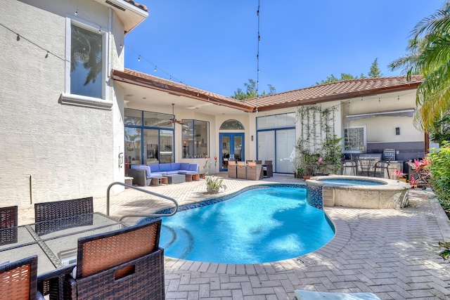 view of swimming pool featuring a pool with connected hot tub, ceiling fan, french doors, outdoor lounge area, and a patio area