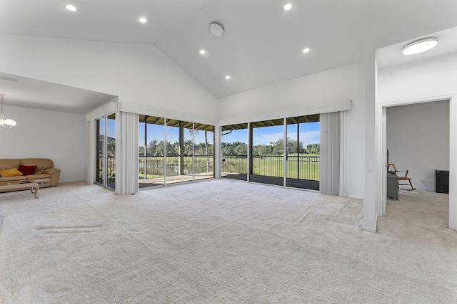 unfurnished living room featuring light colored carpet, high vaulted ceiling, and a healthy amount of sunlight