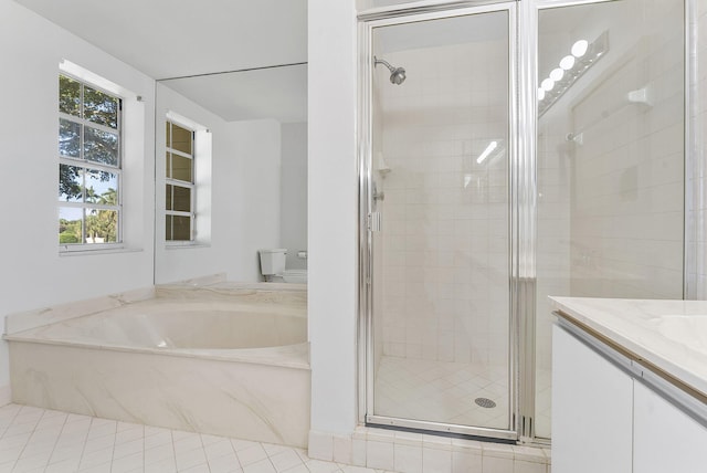 full bathroom with plus walk in shower, vanity, tile patterned floors, and toilet