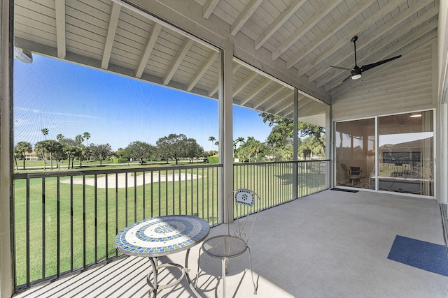 unfurnished sunroom featuring lofted ceiling with beams and ceiling fan