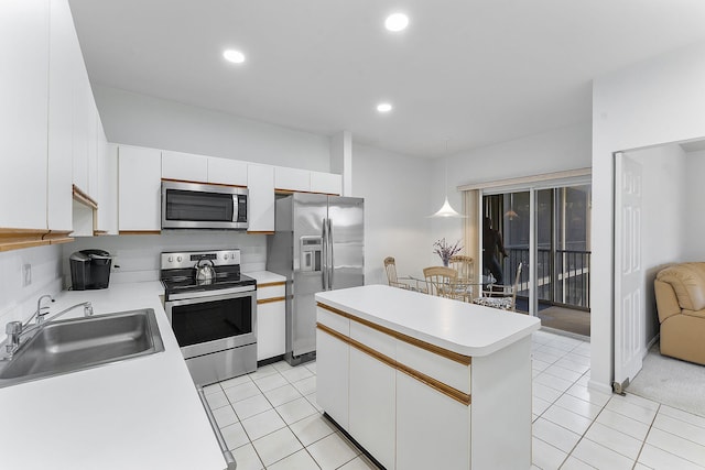 kitchen with pendant lighting, a center island, white cabinets, sink, and stainless steel appliances