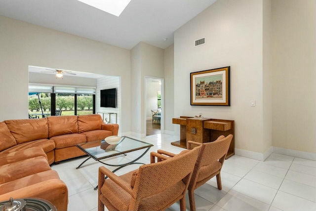 living room with ceiling fan and light tile patterned floors