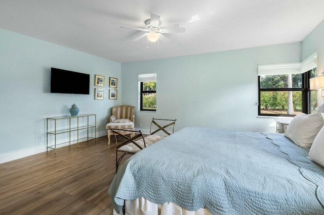 bedroom with ceiling fan and dark hardwood / wood-style floors