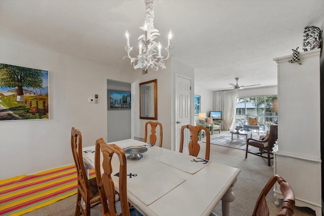 dining area with light carpet and ceiling fan with notable chandelier