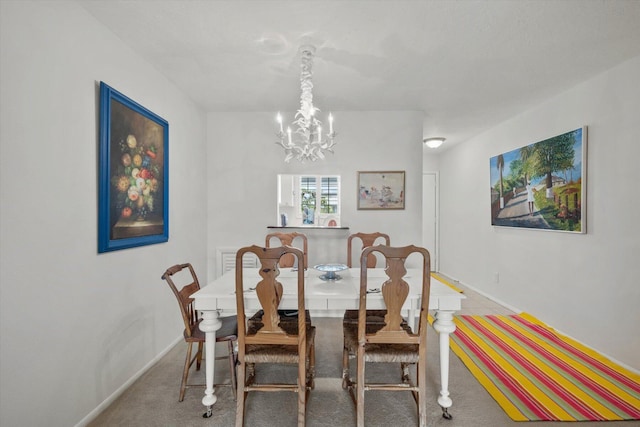 carpeted dining room featuring a notable chandelier