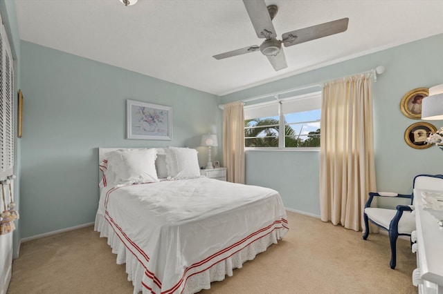 bedroom with ceiling fan and light carpet