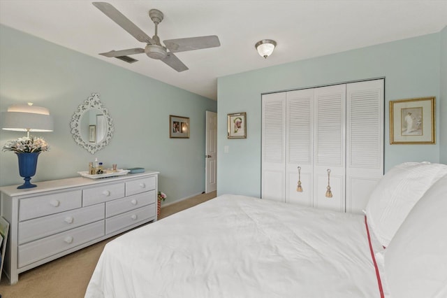 bedroom featuring ceiling fan, light carpet, and a closet