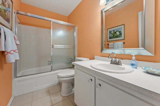 full bathroom featuring toilet, tile patterned flooring, vanity, and combined bath / shower with glass door