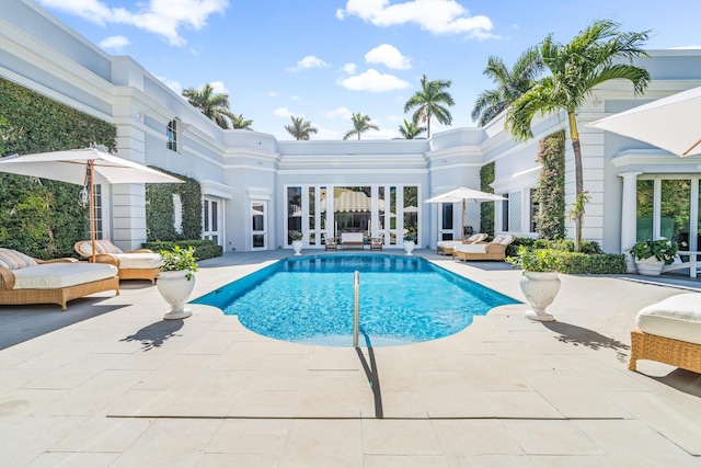 pool with a patio area and an outdoor hangout area