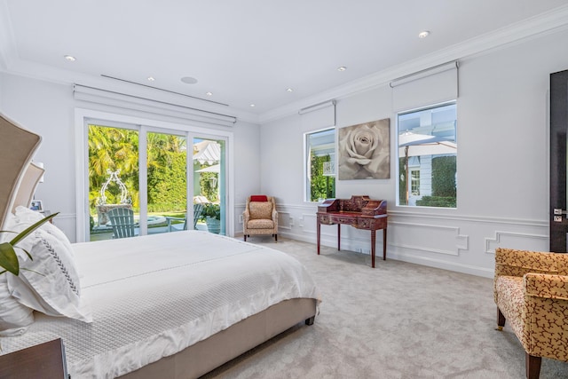 bedroom with crown molding, a decorative wall, multiple windows, and light colored carpet