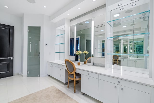 full bathroom with baseboards, a stall shower, vanity, and tile patterned floors