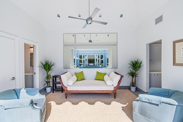 living room featuring visible vents, high vaulted ceiling, a ceiling fan, and baseboards