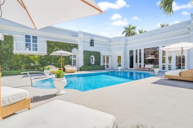 pool featuring french doors and a patio area