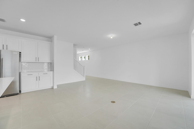 unfurnished living room with light tile patterned floors