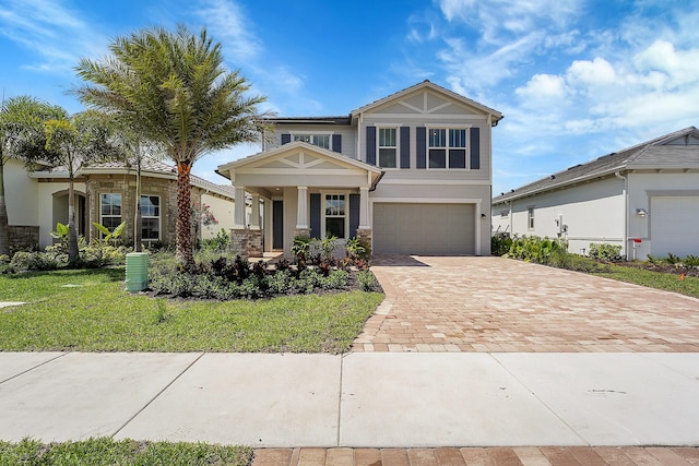 view of front of home with a garage and a front lawn