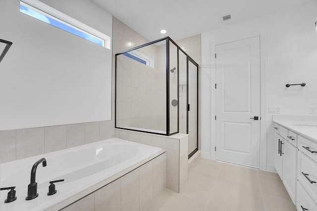 bathroom featuring tile patterned floors, vanity, and plus walk in shower