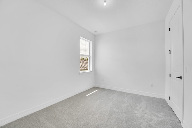 spare room with light colored carpet