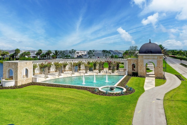 view of swimming pool with a yard and a patio area