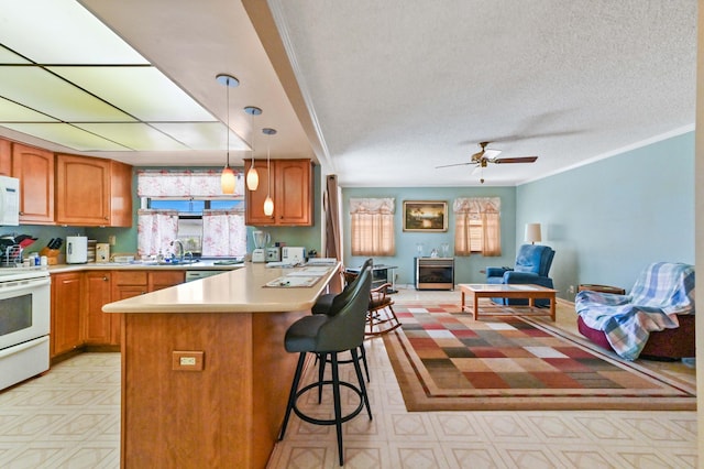 kitchen featuring sink, white appliances, decorative light fixtures, a kitchen bar, and ornamental molding